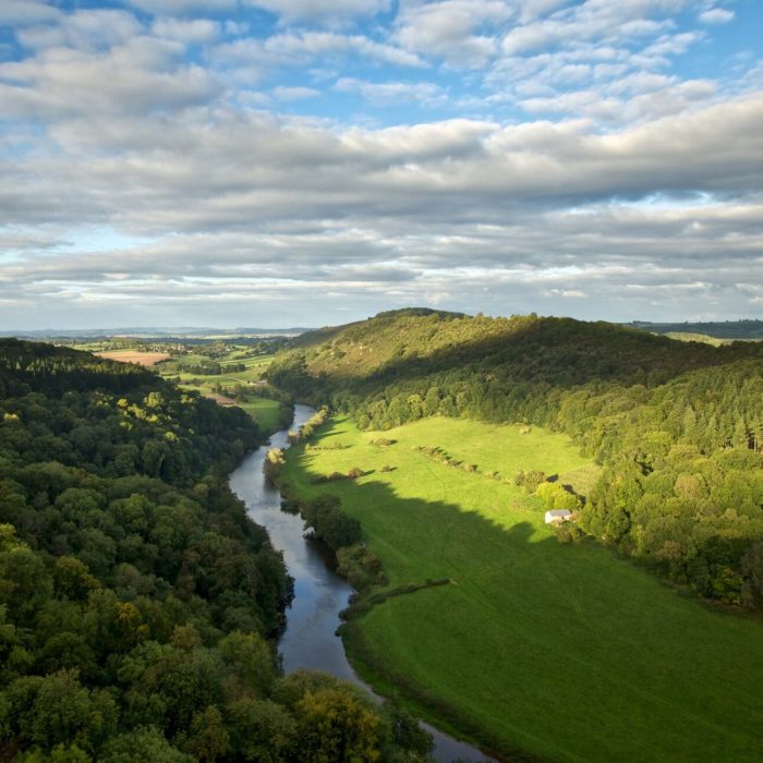 a view of Symonds Yat Rock with the sun shining from behind over looking the wye valley.